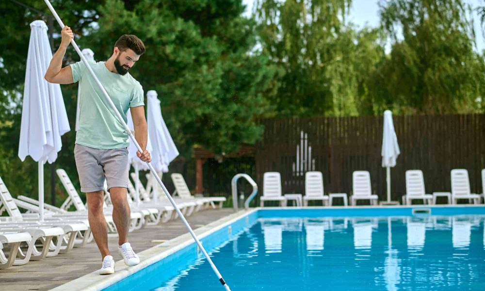 a-service-person-cleaning-the-swimming-pool-and-looking-busy.jpg